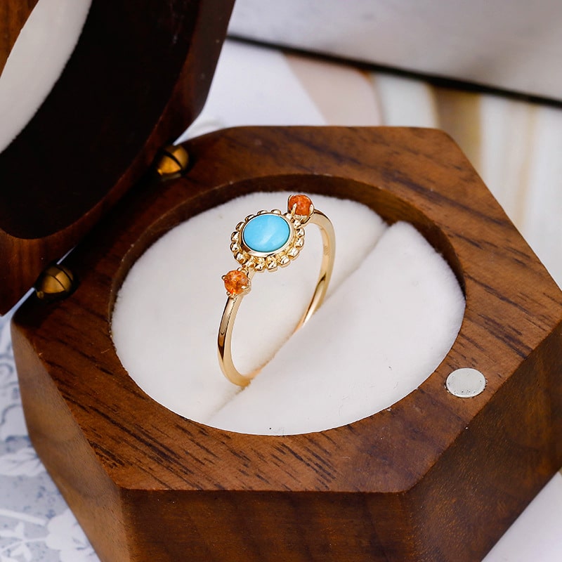 Turquoise and sunstone ring in wooden jewelry box