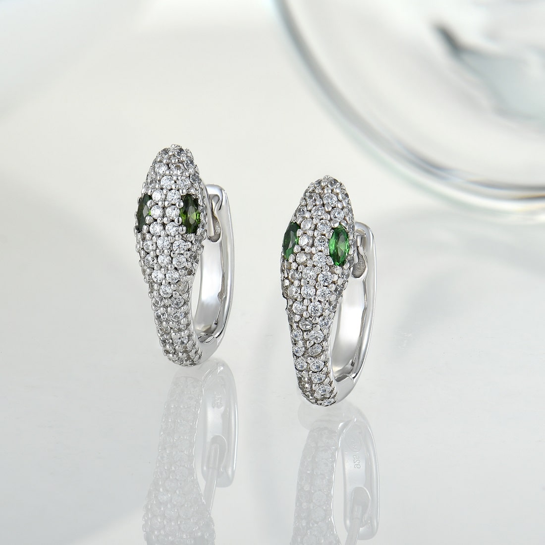 Sterling silver snake earrings with green zircons